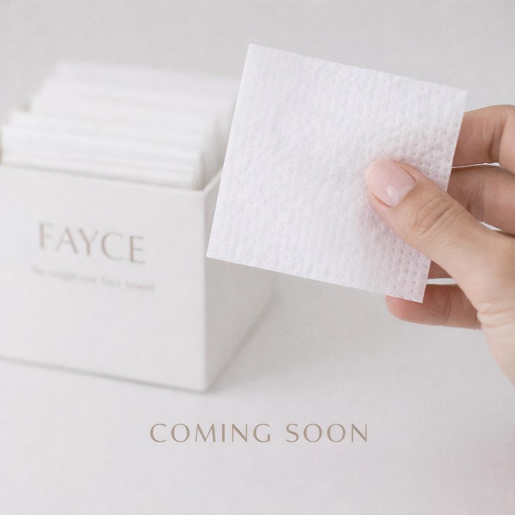 Hand pulling a disposable face towel from a FAYCE box with coming soon caption