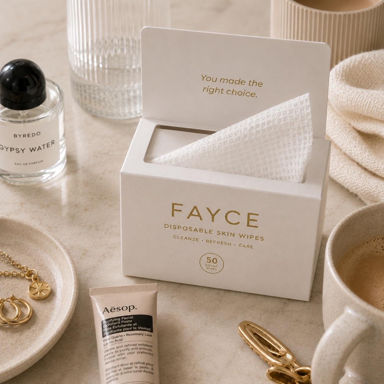 FAYCE disposable skin wipes box in a flatlay with skincare products