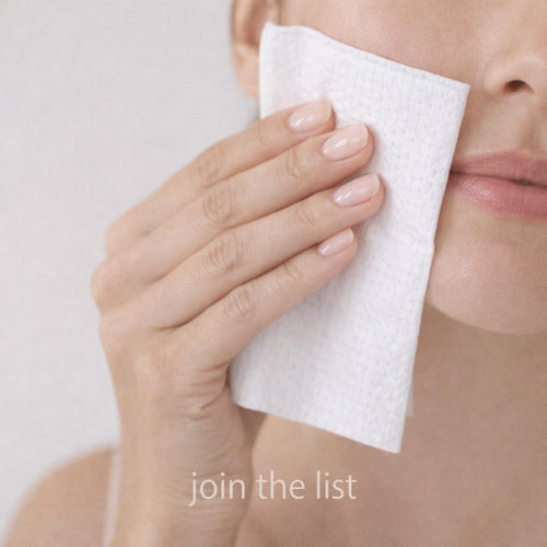 Woman gently wiping her face with a FAYCE disposable face towel